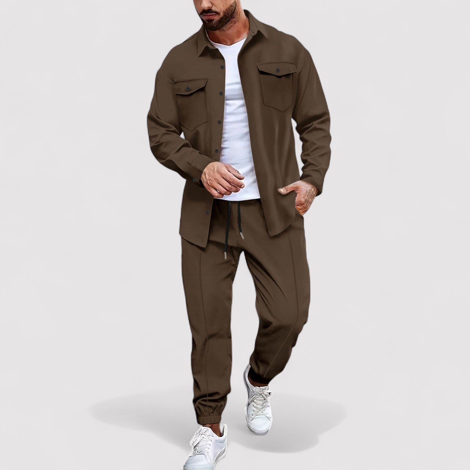 Man wearing a brown jacket and pants set on a white background